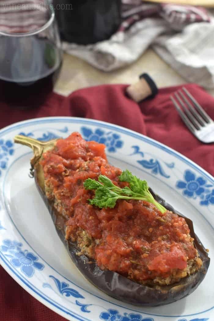 Stuffed Eggplant | Delicious eggplant stuffed with spicy sausage and topped with homemade red sauce!