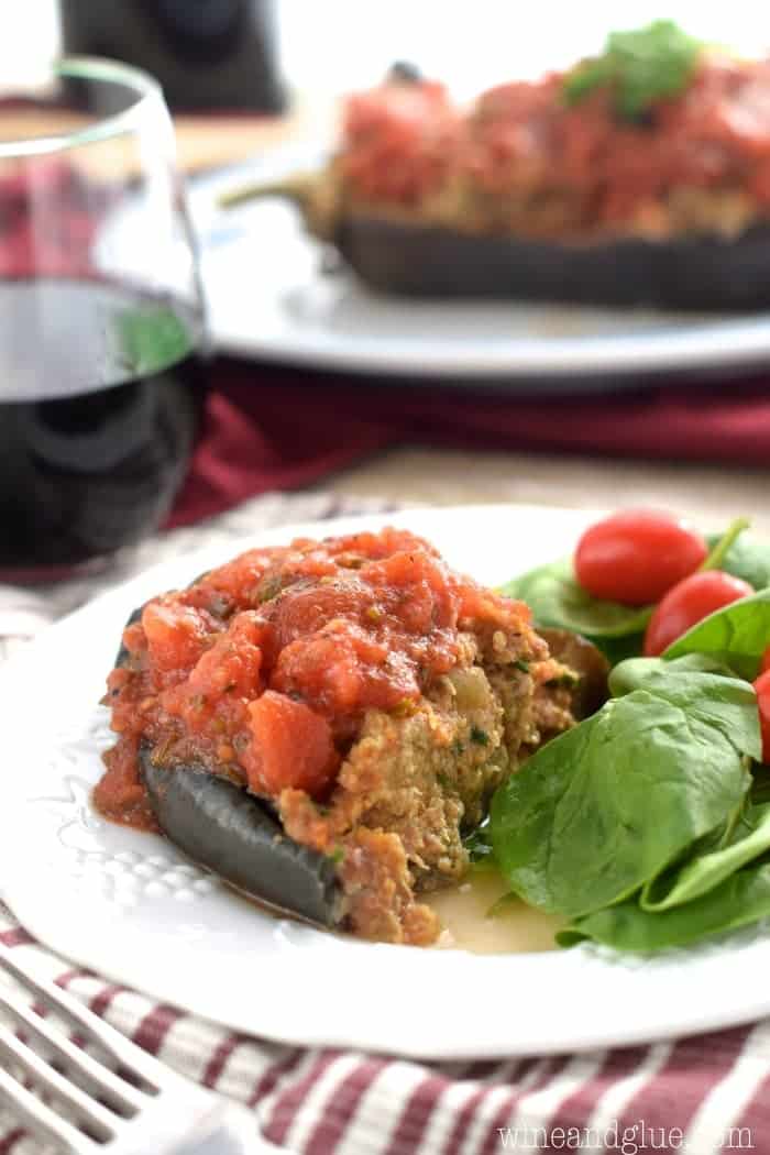 This Stuffed Eggplant is an old family favorite. Tender eggplant and spicy sausage topped with homemade red sauce, this hearty dish is stuffed with flavor!