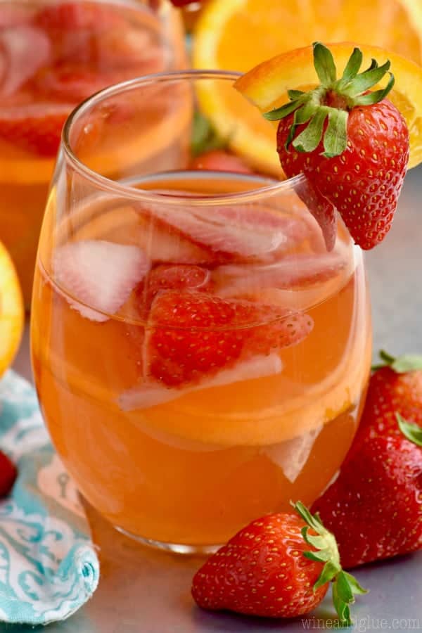 This Sunset Sangria is made with orange, strawberry, rum and will quickly become a favorite!