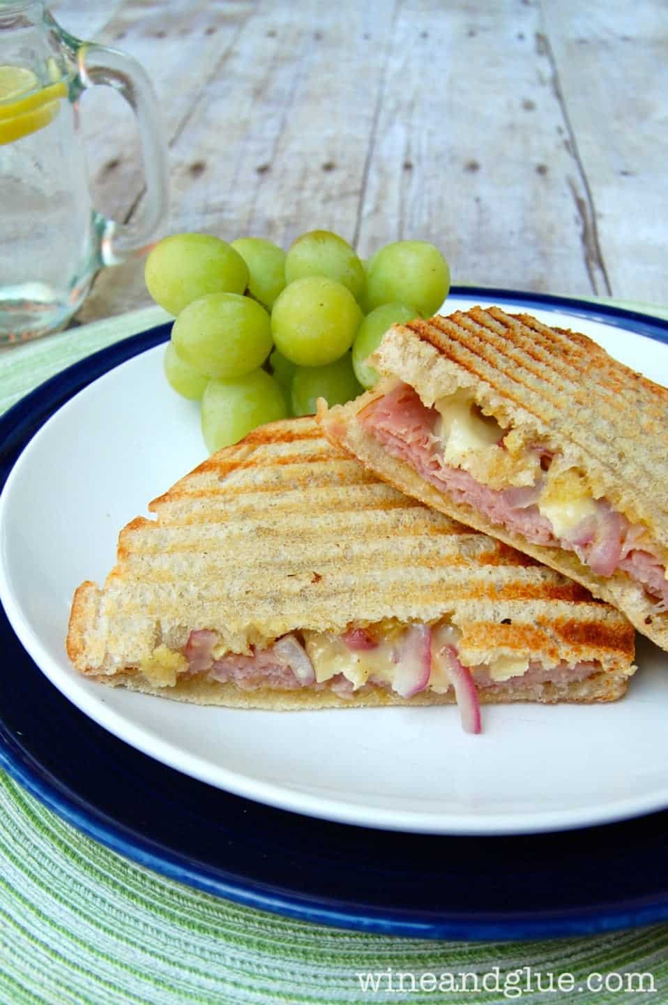 Ham and Brie Panini mixes the most delicious flavors into an easy panini that will make you feel like you are having lunch in a fancy cafe via www.wineandglue.com