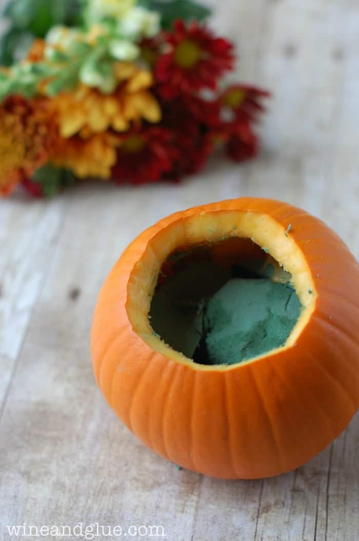 small pumpkin that has top cut off with floral foam in it