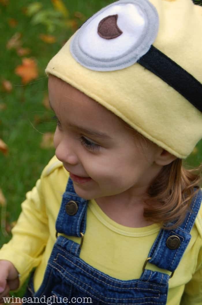 Little girl wearing a homemade Minion Costume and easy to sew Minion hat