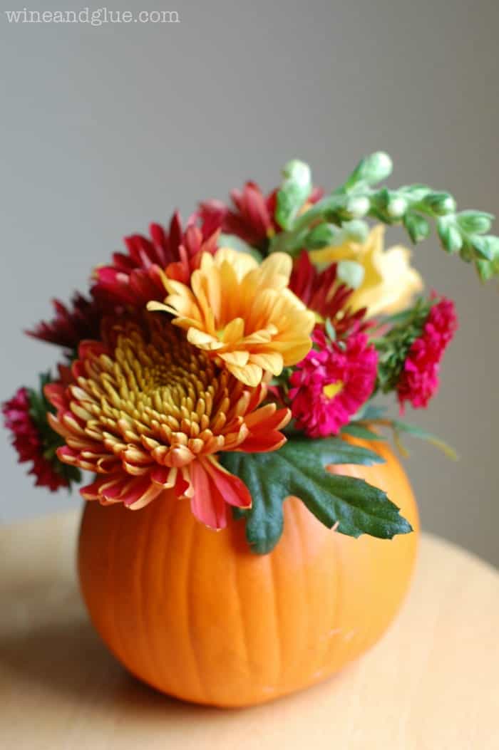 small pumpkin with flowers sticking out of it