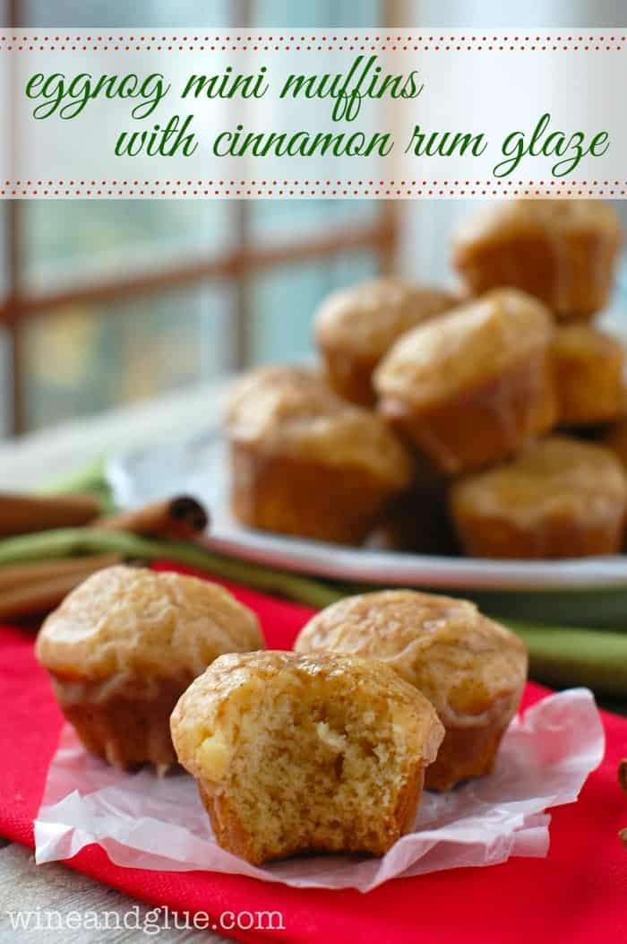 a group of three eggnog muffins with a bite missing off the front one and a plate of more in the background, says: "eggnog mini muffins with cinnamon rum glaze"