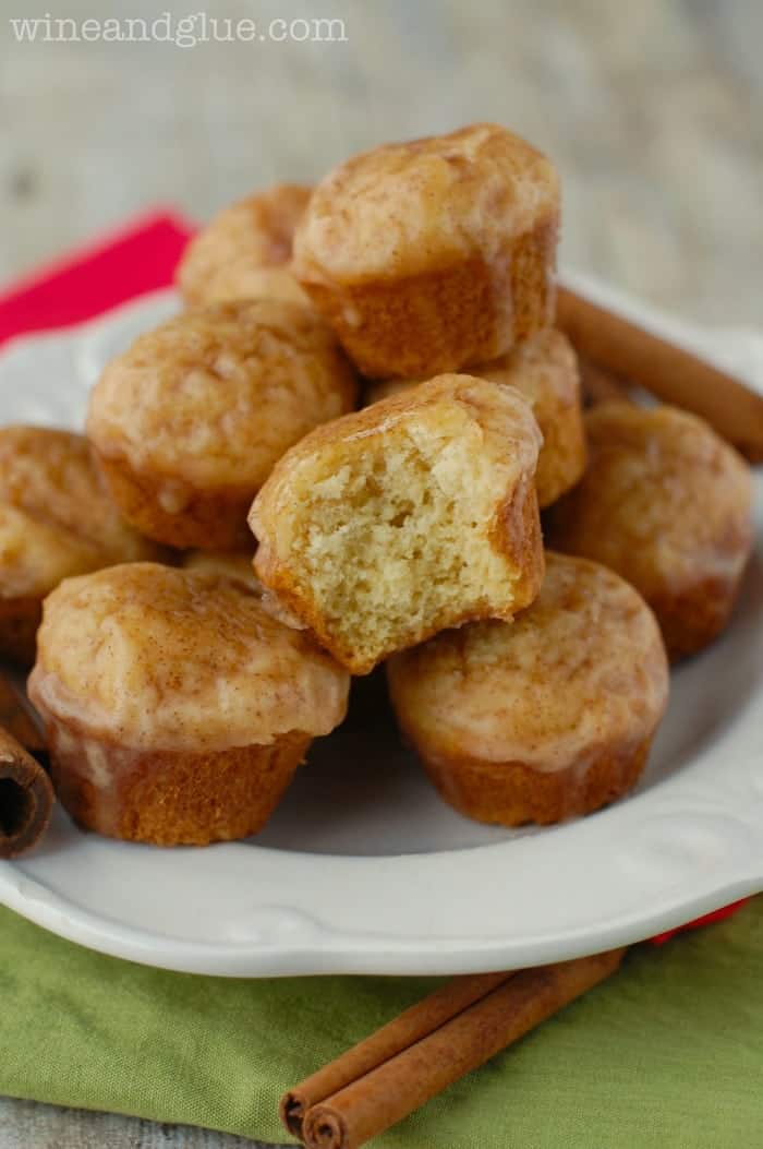 a plate of eggnog mini muffins; one with a bite missing