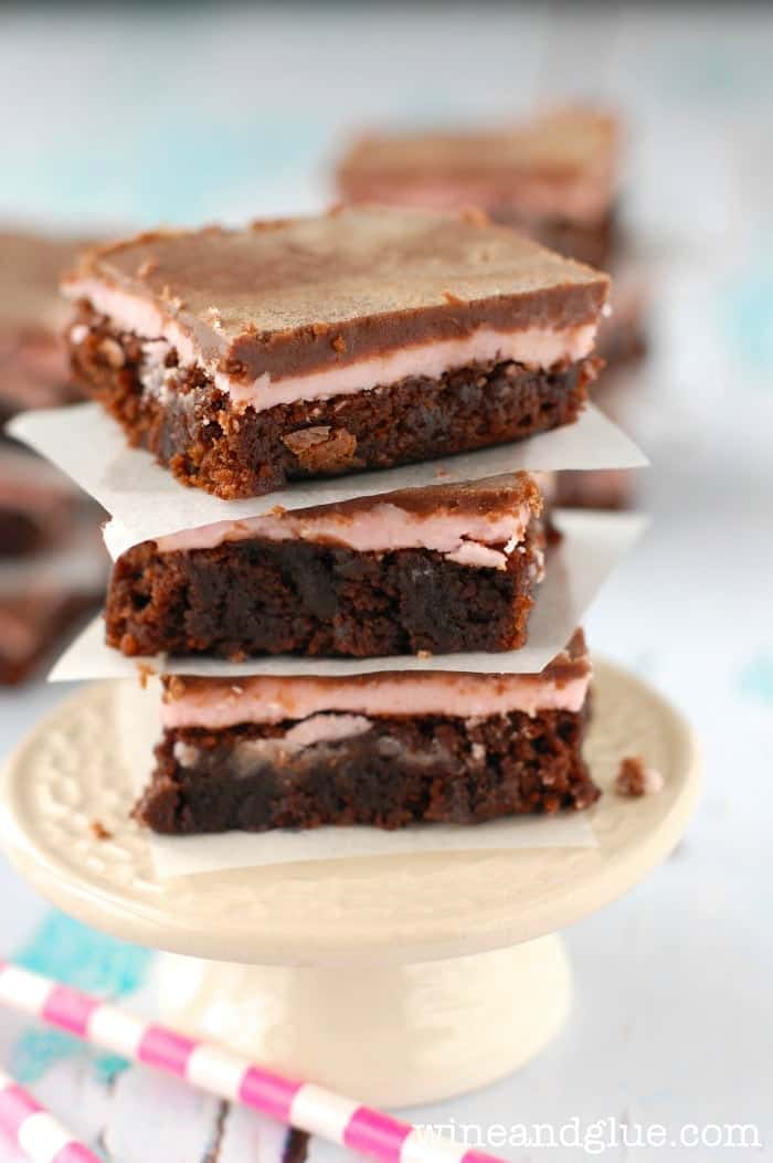 side view of stack of raspberry brownies on a tiny cake stand