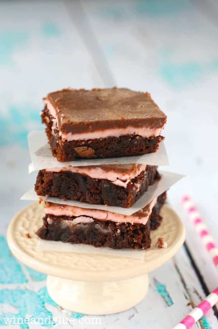 stack of three raspberry brownies on a small cake stand