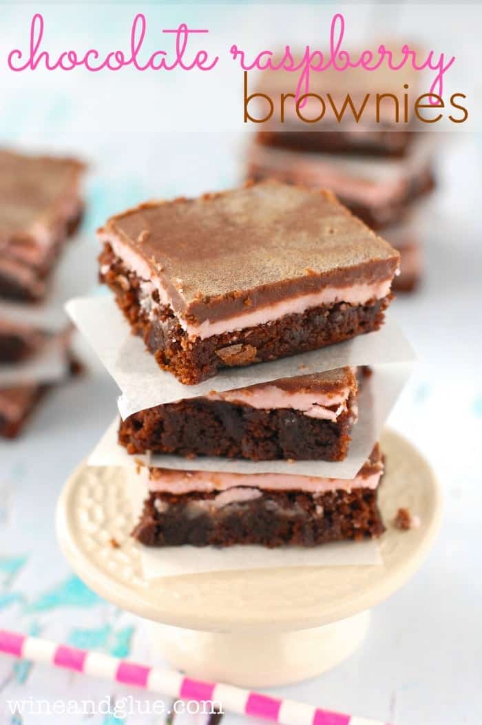 stack of three chocolate raspberry brownies on a small cake stand, says "chocolate raspberry brownies"