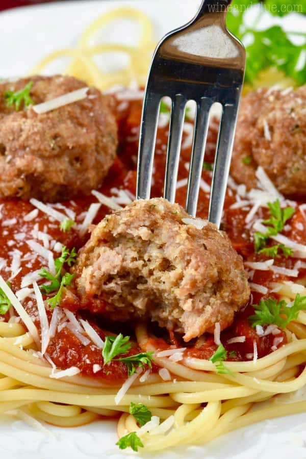 Healthy meatball with one bite taken out of it. 