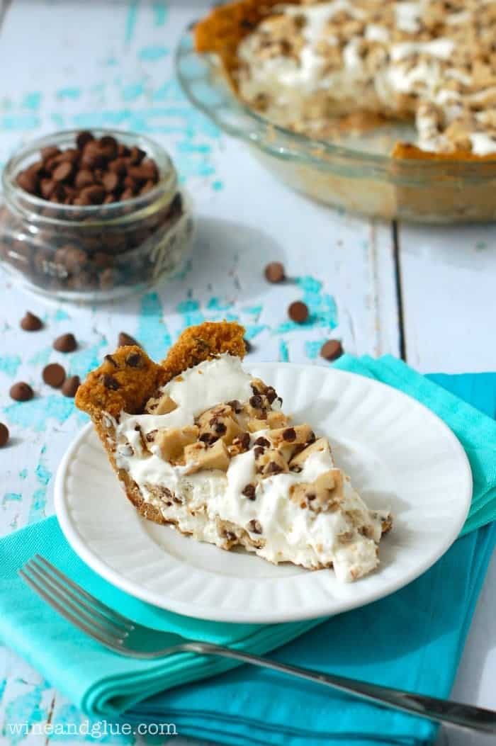 Cookie Dough Ice Cream Pie on a plate with the rest of the pie in the background