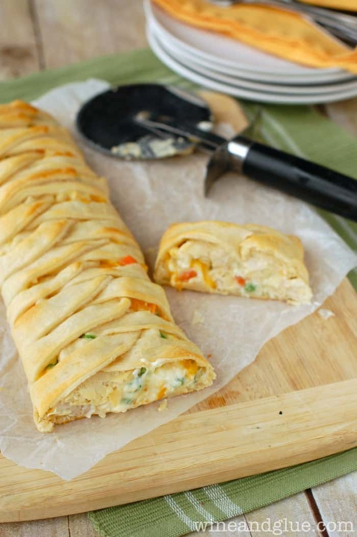 pulled back look of a chicken pot pie crescent braid on a cutting board with the front cut off