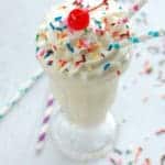 overhead of a Funfetti Milkshake topped with sprinkles and a cherry