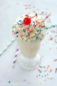 overhead of a Funfetti Milkshake topped with sprinkles and a cherry