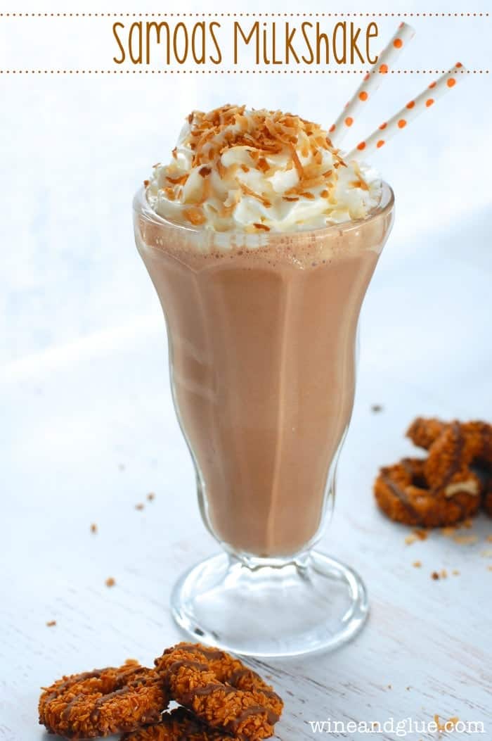 side view of a samoa milkshake with whipped cream and toasted coconut