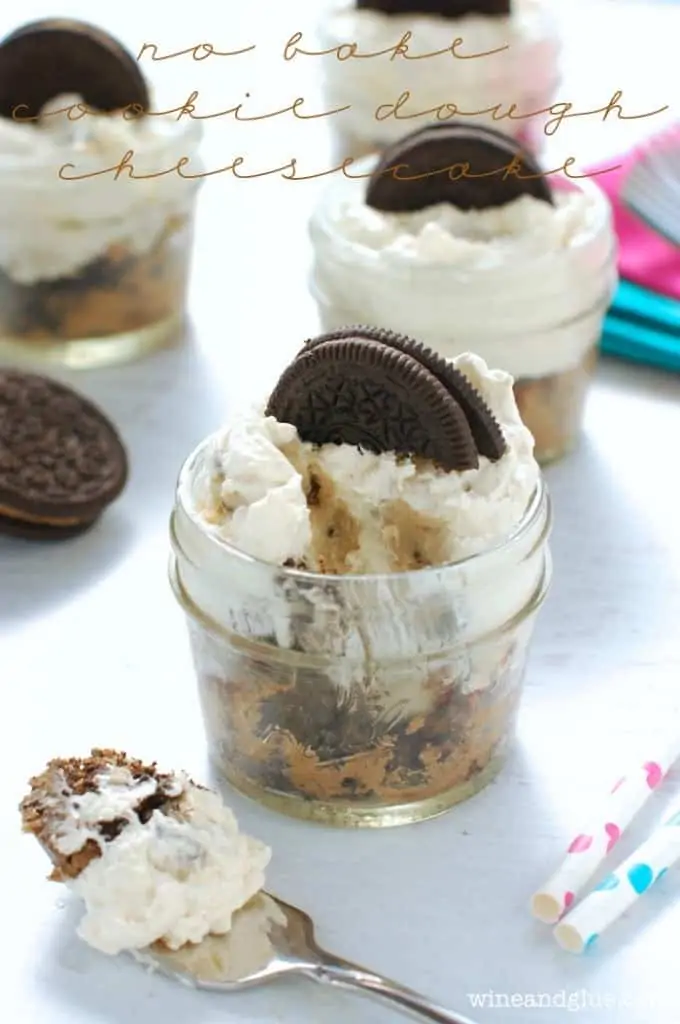 small mason jar full of cookie dough cheesecake with bite missing