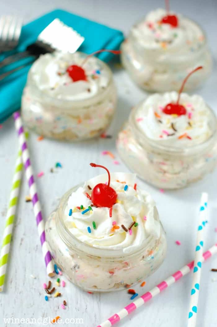 several small mason jars filled with cheesecake