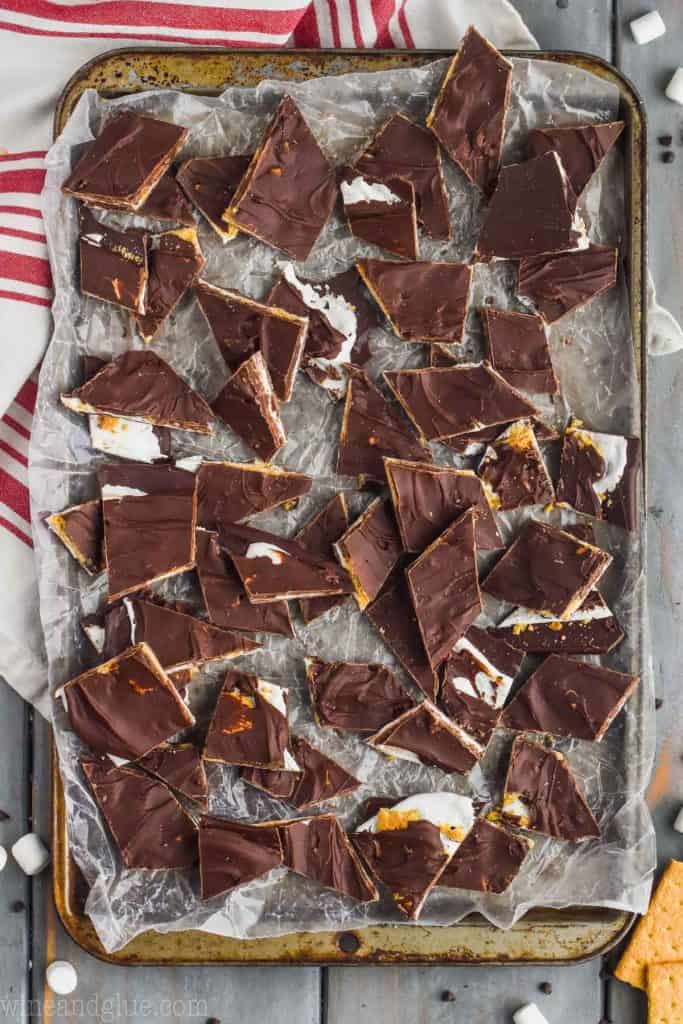 overhead view of broken up chocolate bark recipe in a silver pan lined with wax paper