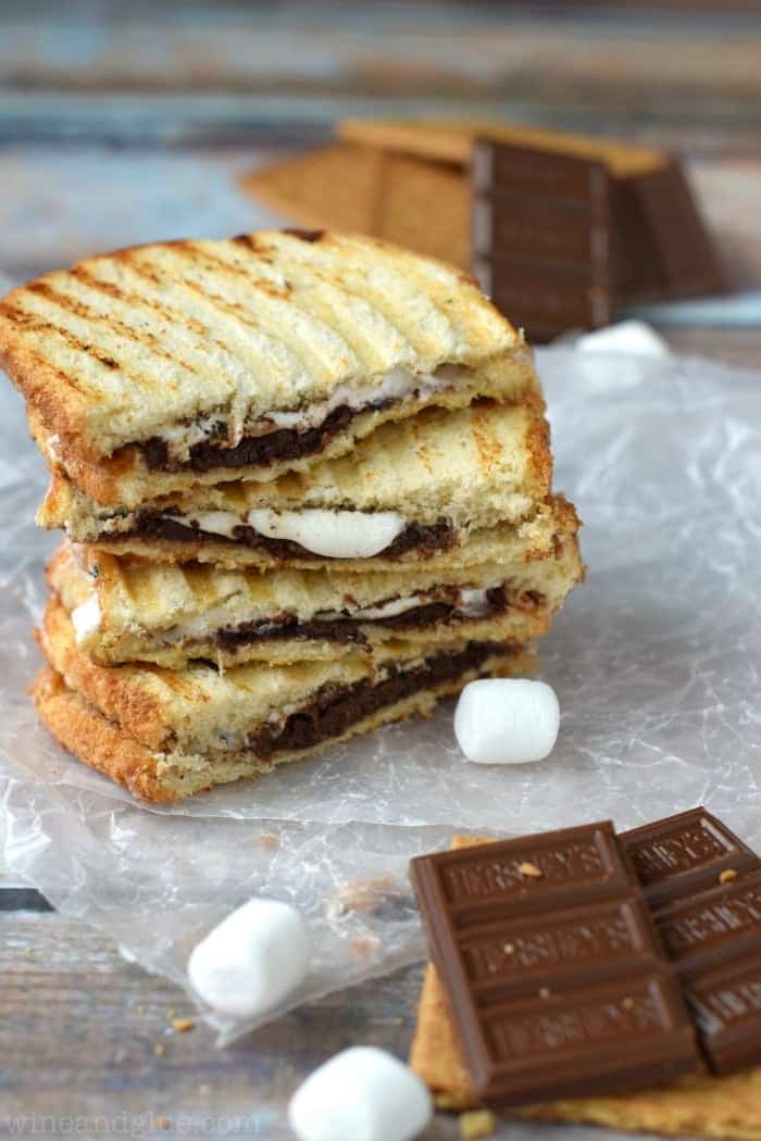 stacked s'mores panini with chocolate, graham crackers and marshmallows in the foreground