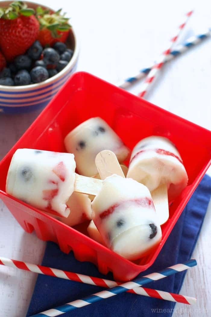 These Strawberry Blueberry Yogurt Pops are so perfect for summer and so easy to make! Blueberry Yogurt Pops | www.wineandglue.com | So perfect for summer and so easy to make!