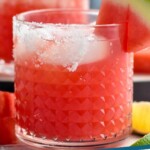 pinterest graphic of close up of a watermelon margarita with salt on the rim and a watermelon wedge on the rim, says: "watermelon margarita simplejoy.com"