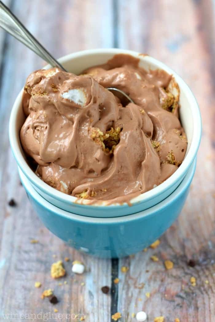 close up of two bowls stacked with Nutella s'mores ice cream in it and a spoons sticking out.