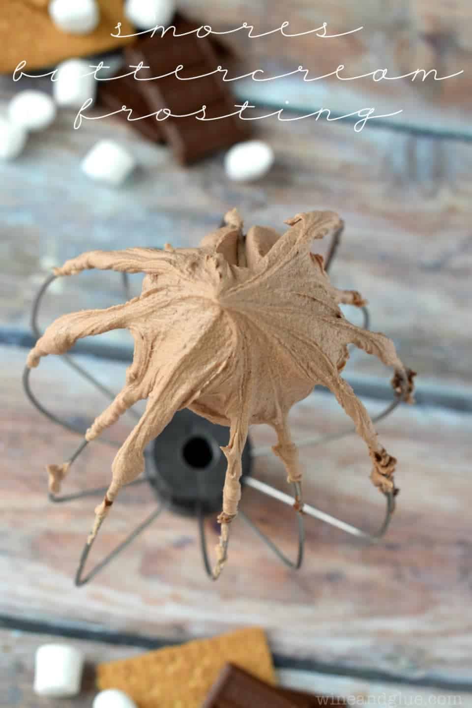 a stand mixer whisk with s'mores frosting on it