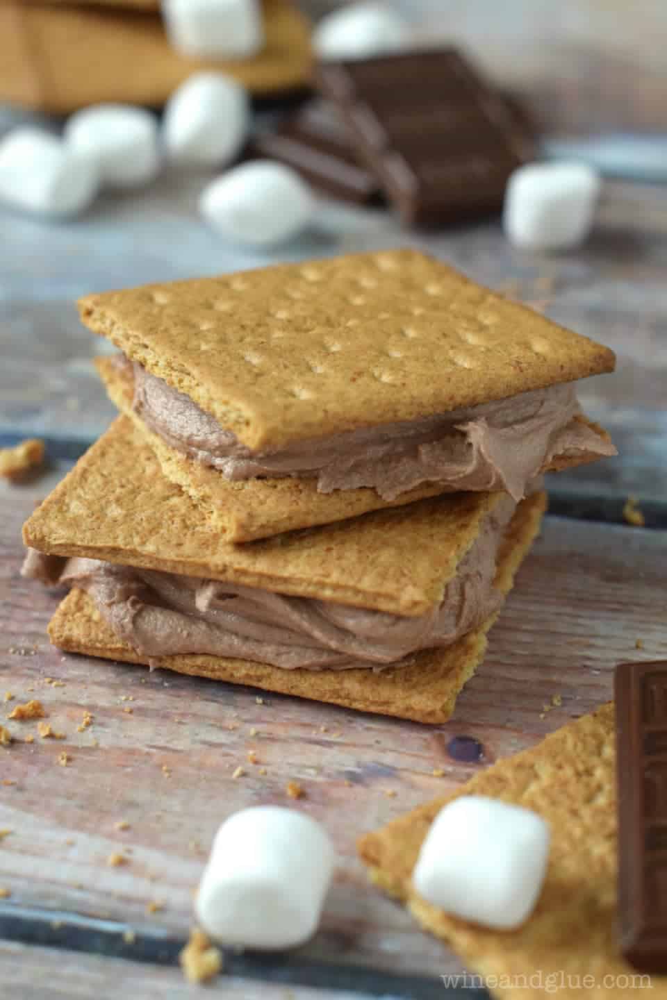 two graham cracker sandwiches with s'mores frosting in them