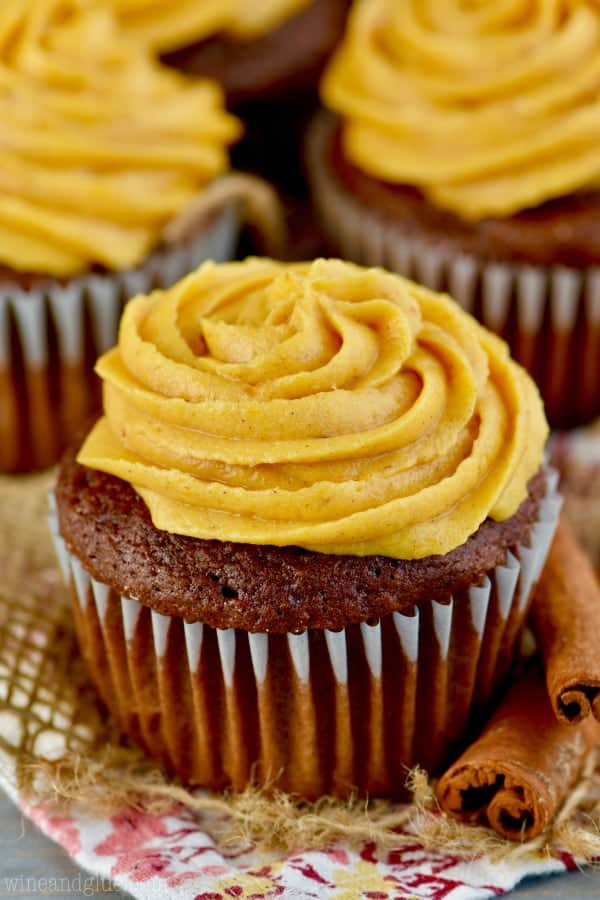 a chocolate cupcake with pumpkin frosting swirled in a rosette pattern