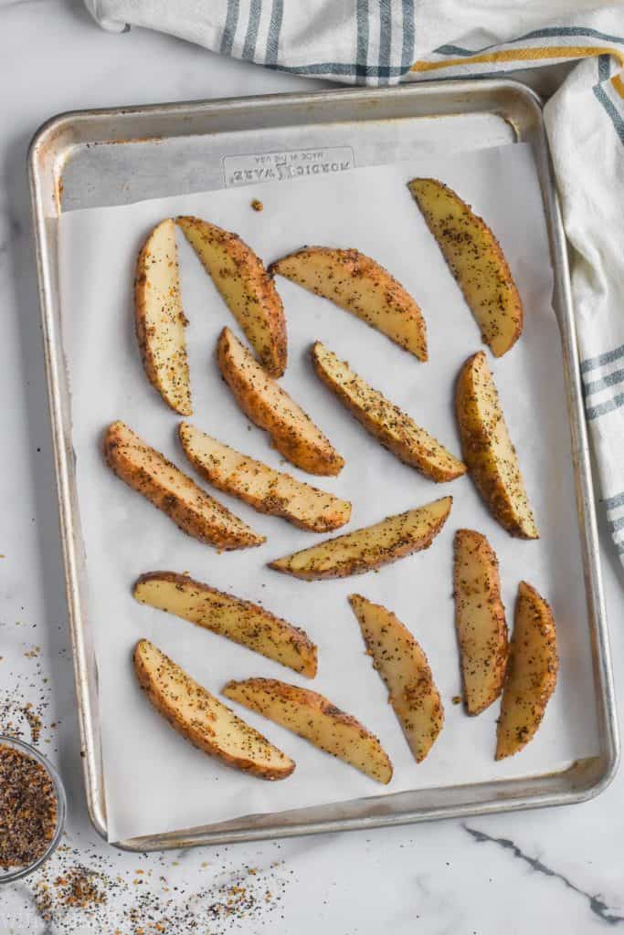 roasted potato wedges on a baking sheet