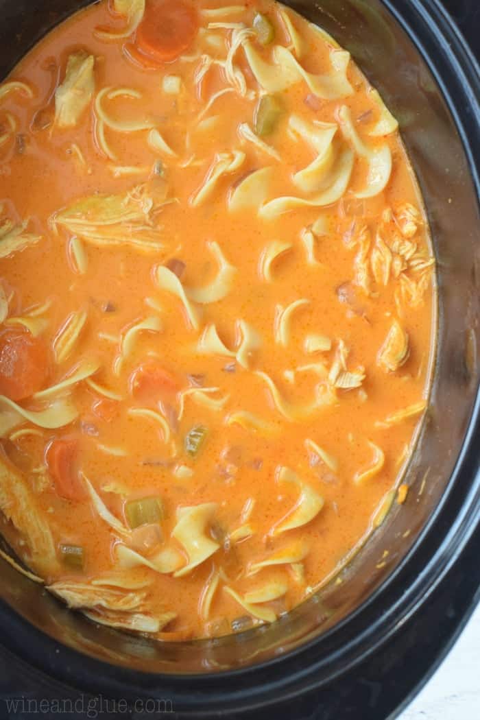 overhead of a slow cooker with buffalo chicken soup in it