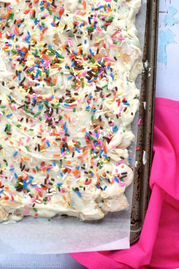 overhead of chocolate bark in a sheet pan with sprinkles on top.