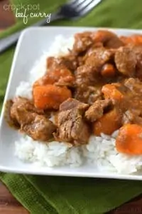 close up of a small plate with rice and crockpot beef curry, says: crock pot beef curry