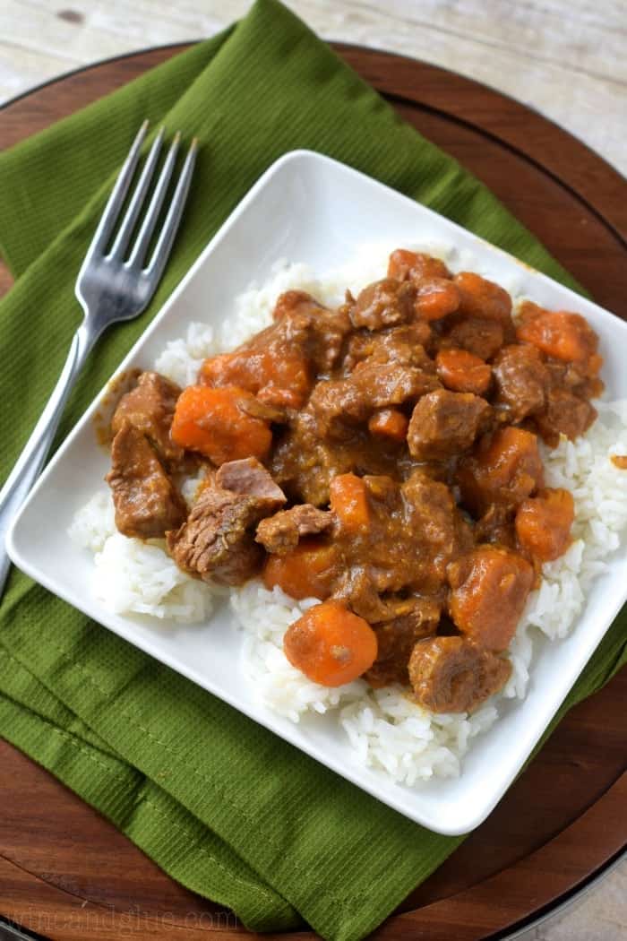 overhead of a square plate with rice and crockpot beef curry