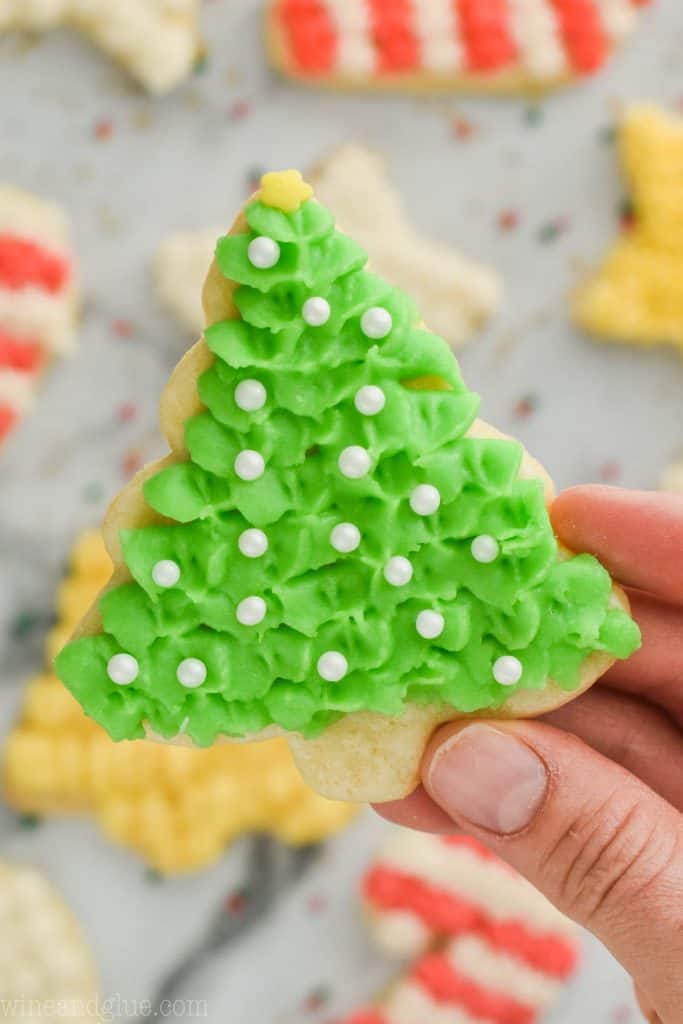 close up of held easy cut out sugar cookie recipe in shape of a christmas tree