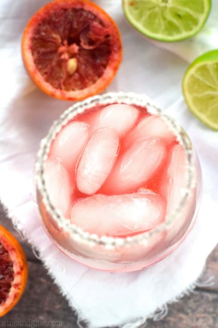 overhead of a blood orange margarita in a stemless wine glass