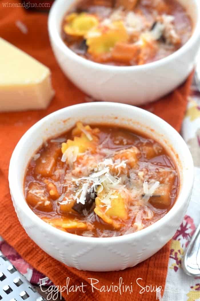 small white bowl with soup says, eggplant raviolini soup