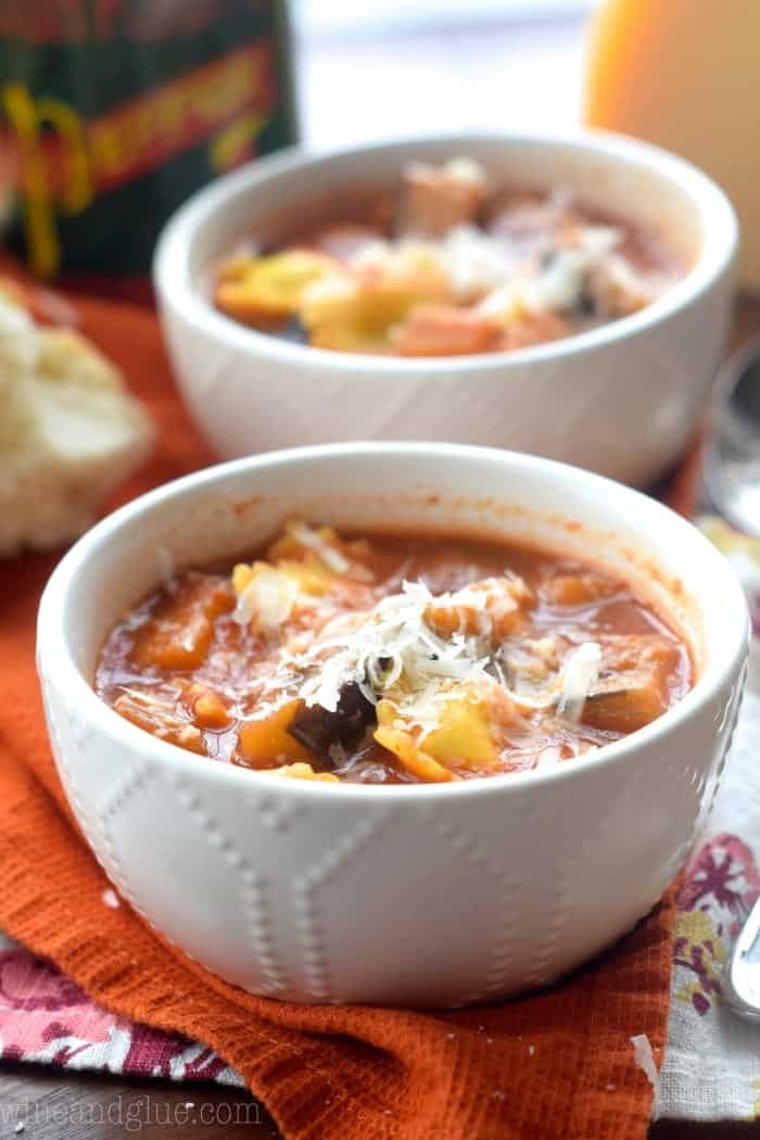 two small bowls of eggplant soup topped with parmesan