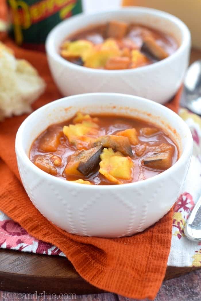 two small bowls of ravioli and eggplant soup