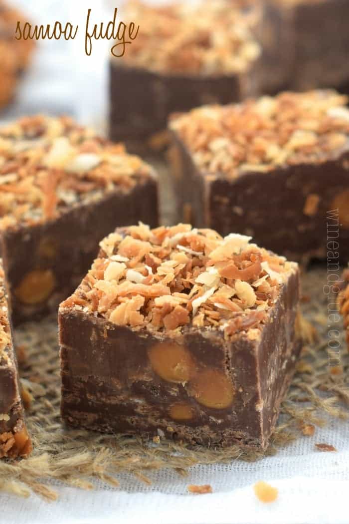 a close up of a piece of some fudge with bits of caramel in it and toasted coconut on top