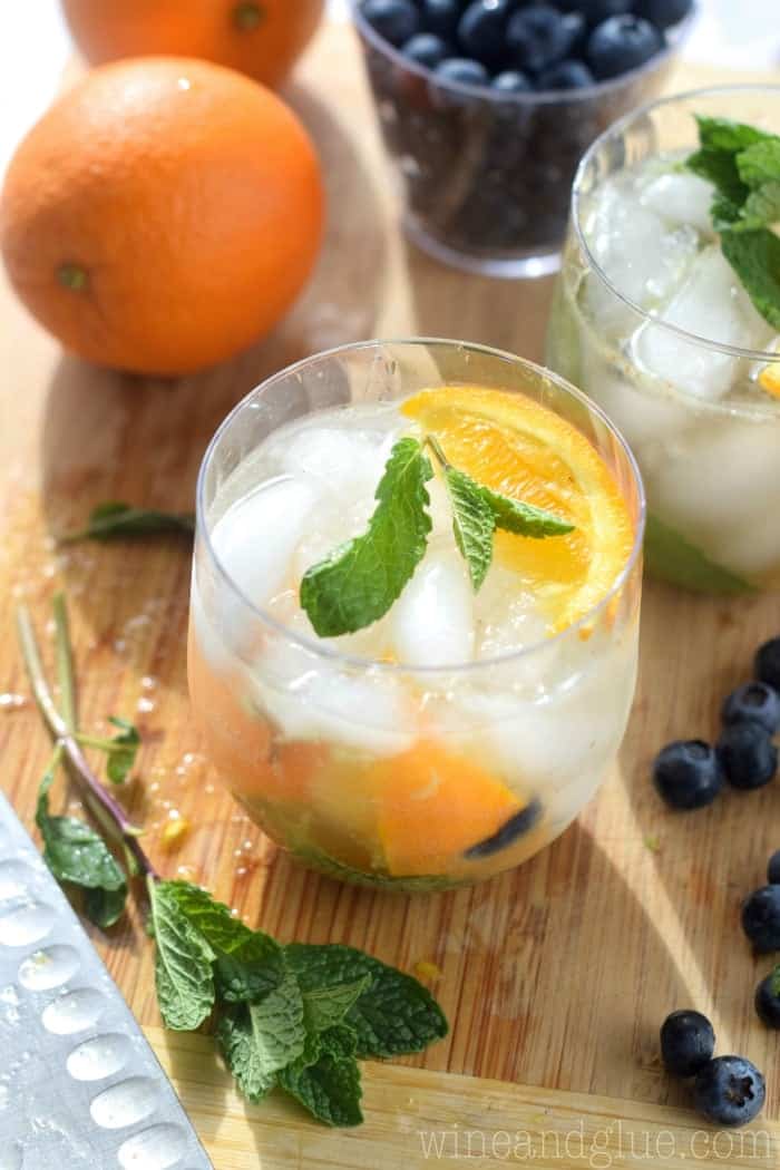 a glass filled with skinny orange blueberry mojito