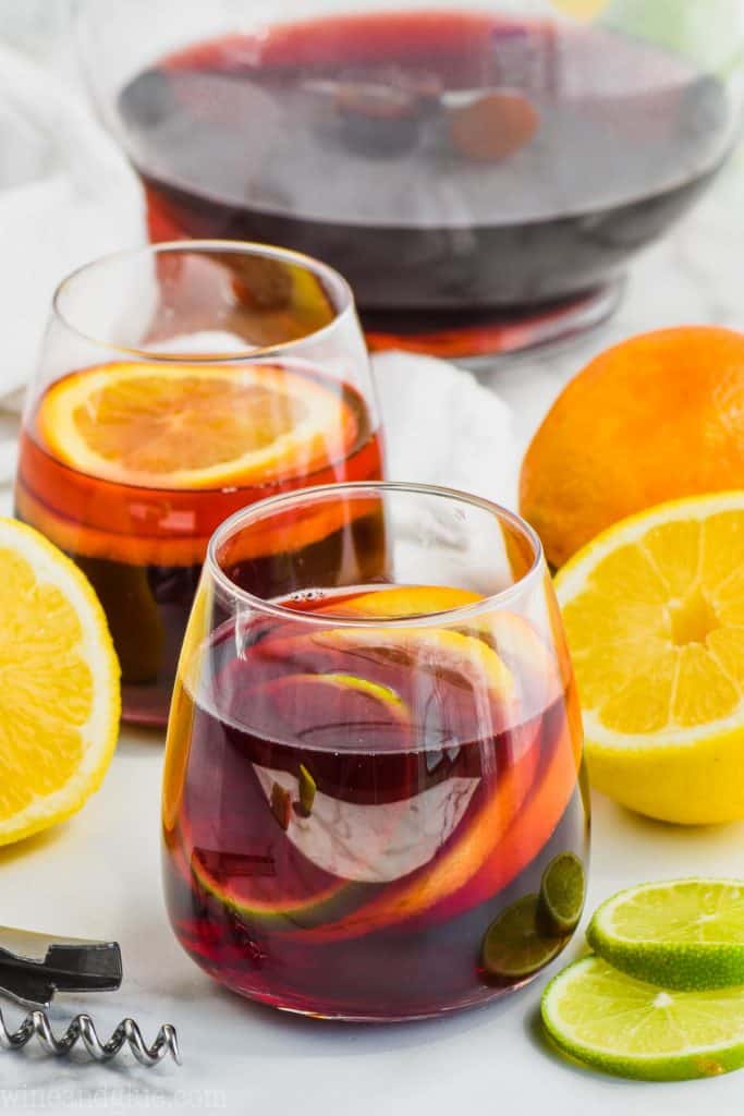 two glasses of red sangria recipe filled with slices of lemon, lime, and oranges