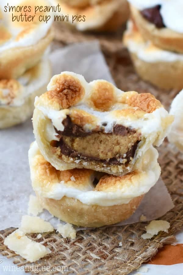 These S'mores Peanut Butter Cup Mini Pies are the deliciousness of a s'mores, smacked with a peanut butter cup, and stuffed inside a pie.  I dare you to only eat one!