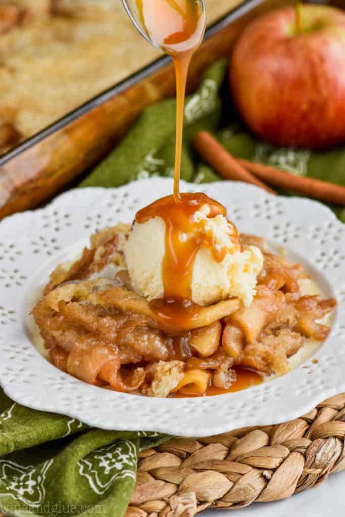 apple cobbler recipe on white plate with ice cream and caramel