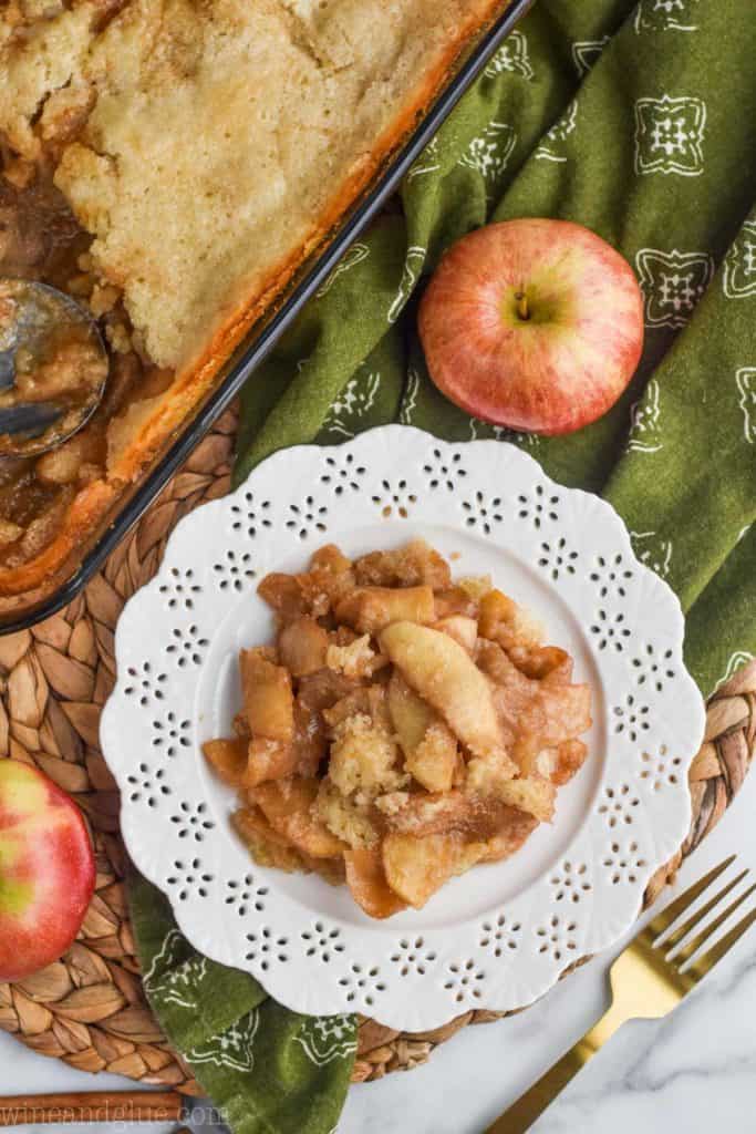 overhead view of from scratch caramel apple cobbler on a white plate