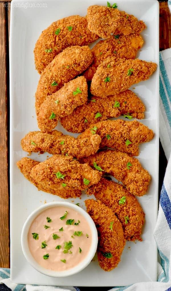 This Baked Chicken Tenders Recipe with Easy Dipping Sauce need to be part of your weeknight dinner line up!  This chicken tender recipe is so delicious and way lighter than traditional fried chicken tenders and barbecue sauce.