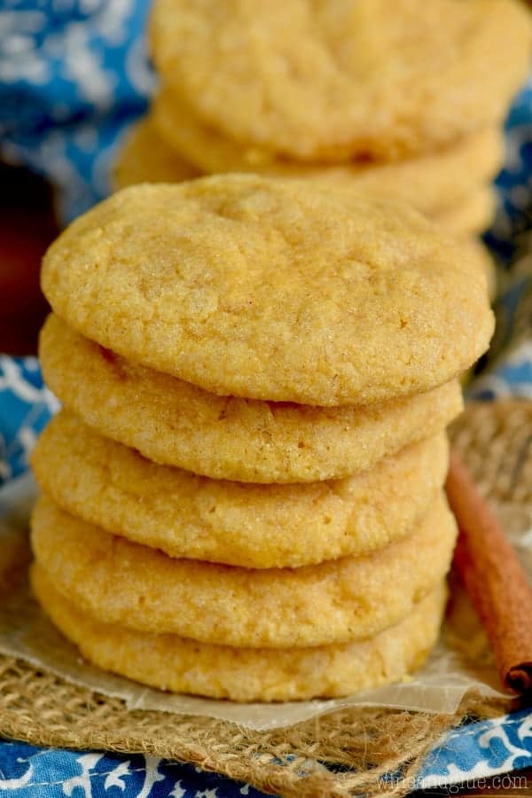 A stack of the Pumpkin Sugar Cookies has a light golden color with a hard exterior and soft interior. 
