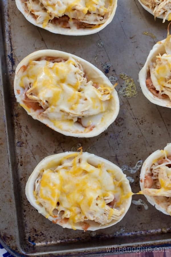 Taco Boats filled with refried beans, shredded chicken, and melted cheddar cheese