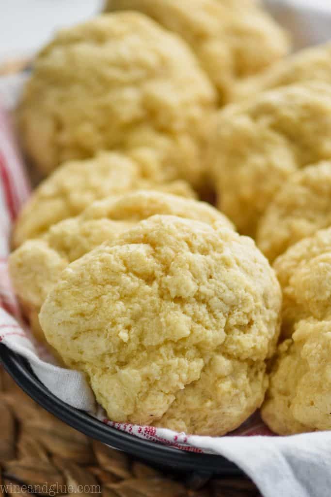 up close picture of fast easy biscuits in a basket lined with a red and white cloth napkin