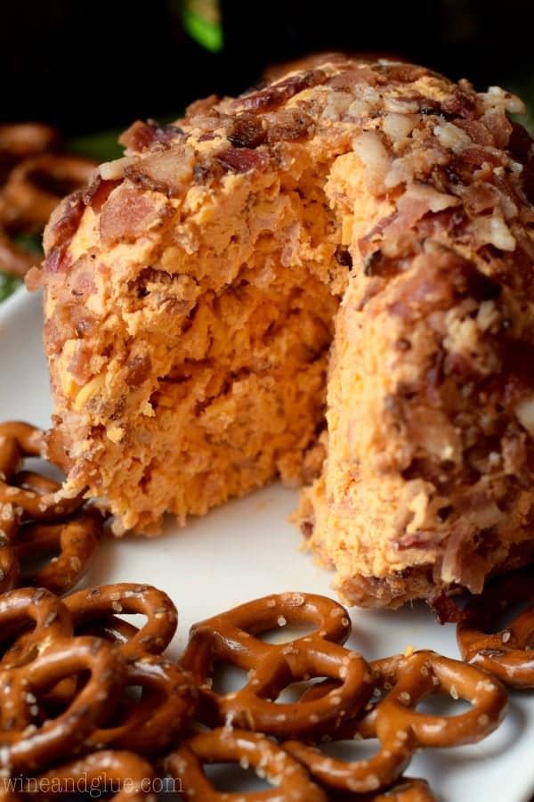 In the middle of the plate, the Buffalo Cheese Ball has a large slice carved out and surrounded by pretzels. 