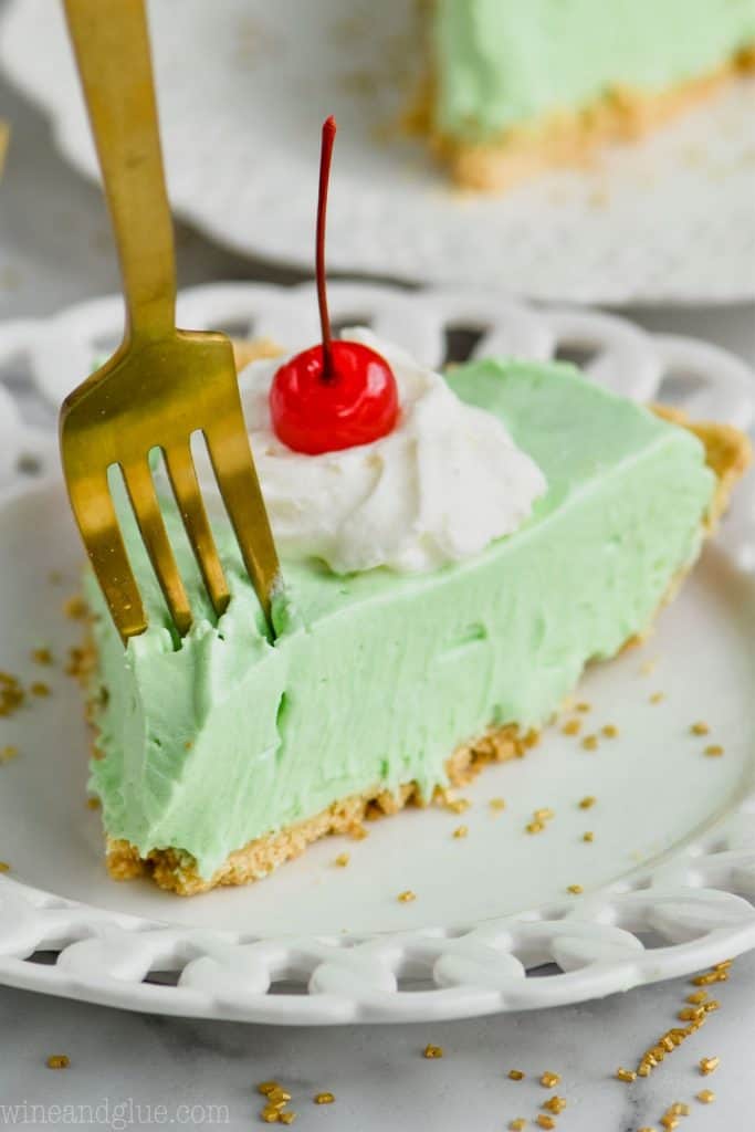 fork digging into a piece of green shamrock shake pie